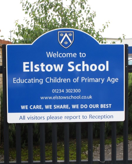 a aluminium school sign on railings at Elstow School